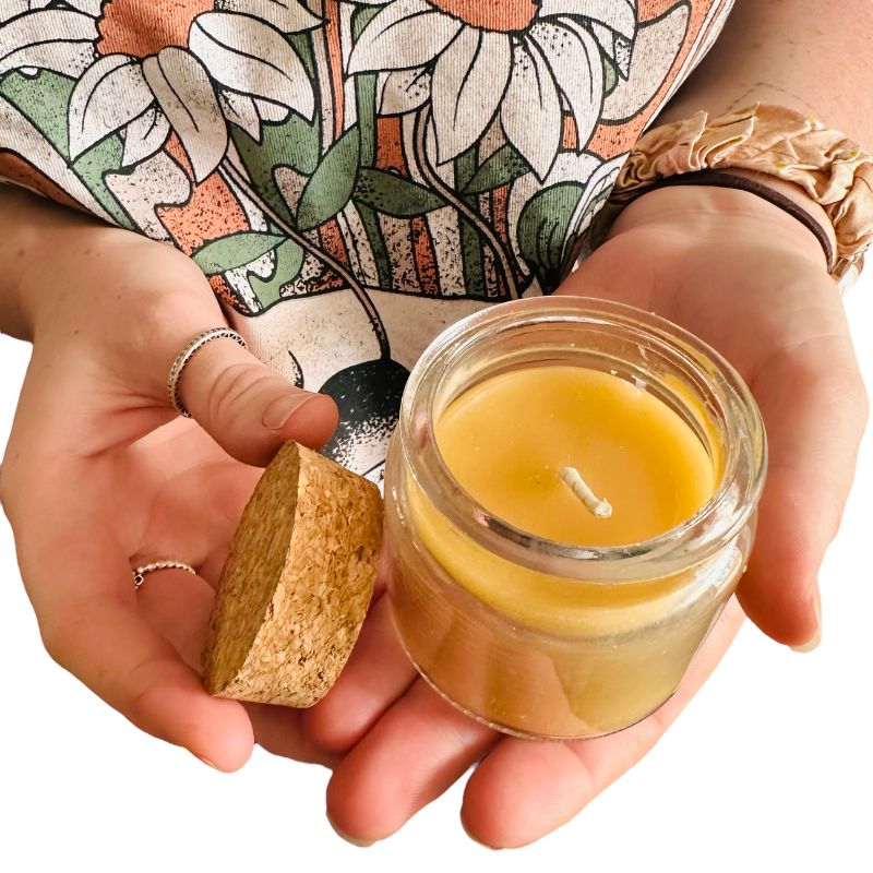 Collombatti Naturals beeswax candle in a glass jar held in two hands