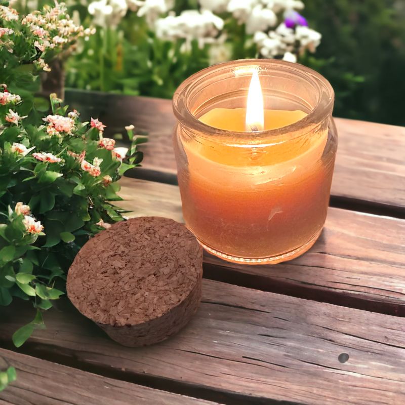 Collombatti Naturals beeswax candle lit on a wooden table 