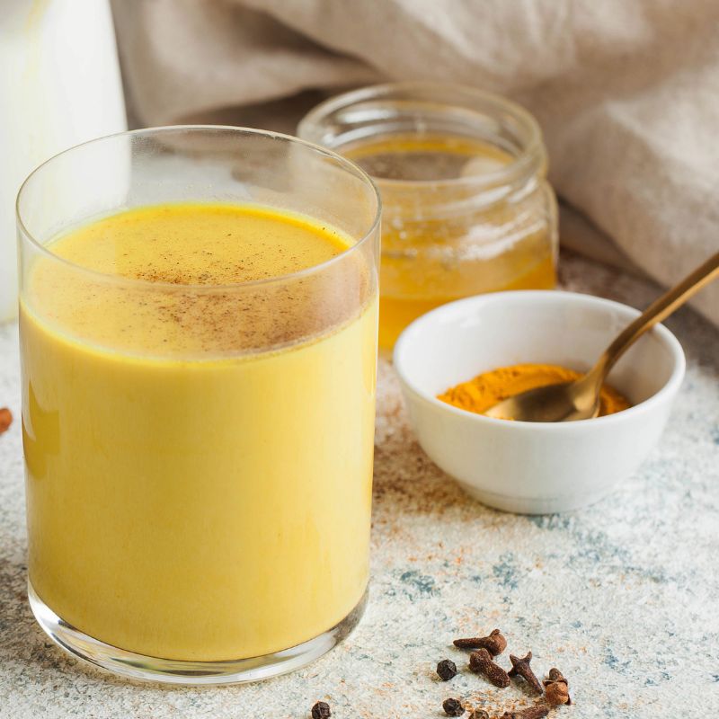 Collombatti Naturals Golden moon milk in a glass cup with cinnamon