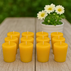 12 pack of beeswax votive candle refills on a wooden table with yellow flowers in the background
