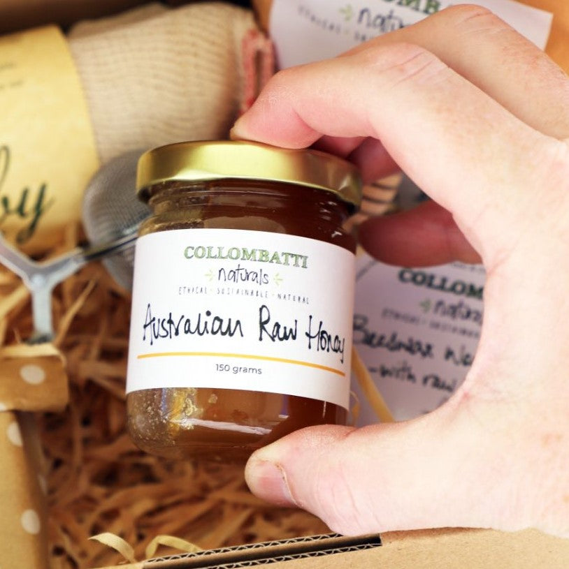 Collombatti Naturals Australian raw honey in a glass jar held in a hand