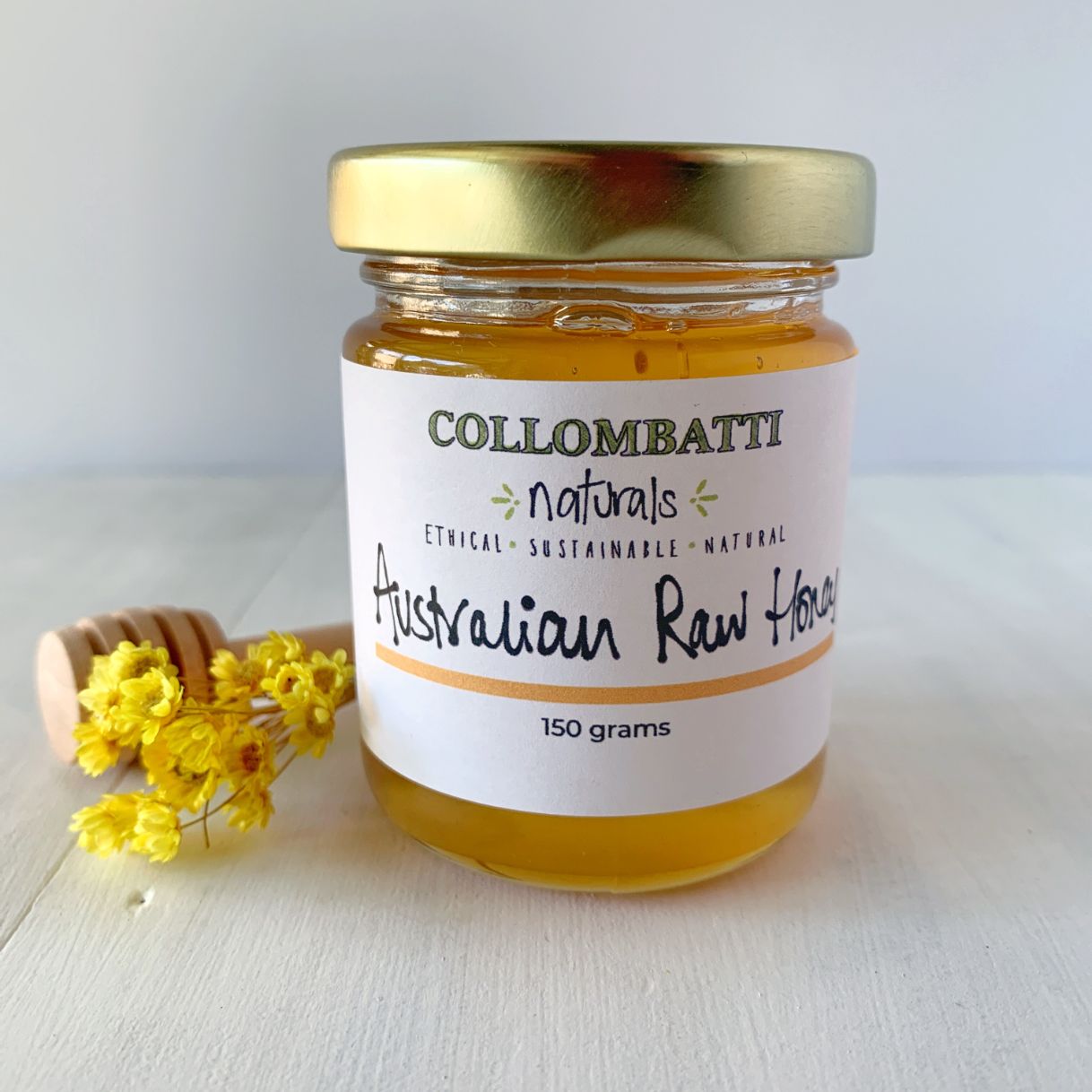 Collombatti Naturals raw Australian honey packed in glass with yellow flowers